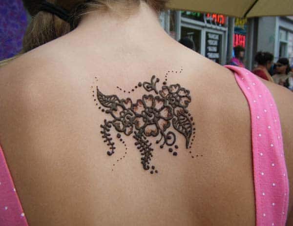 small and cute floral Mehendi design on back for women 