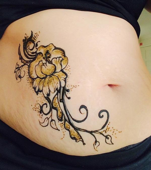An amazing floral mehendi design on stomach for Woman