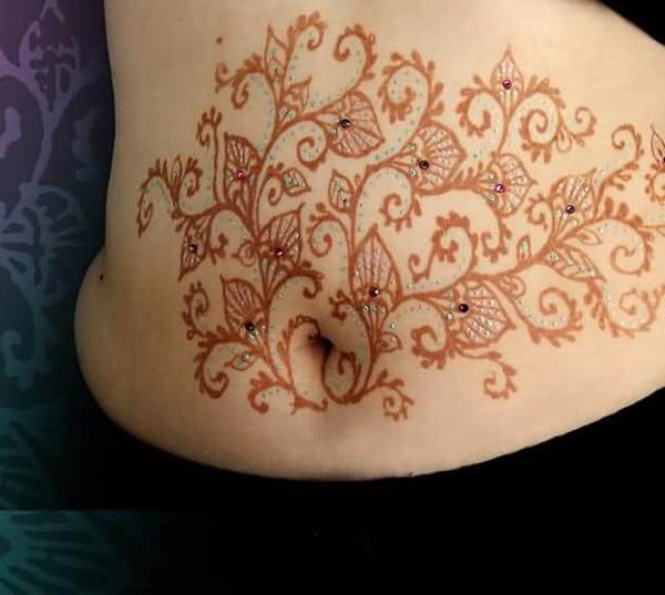 A bejeweled mehndi design on stomach for Woman