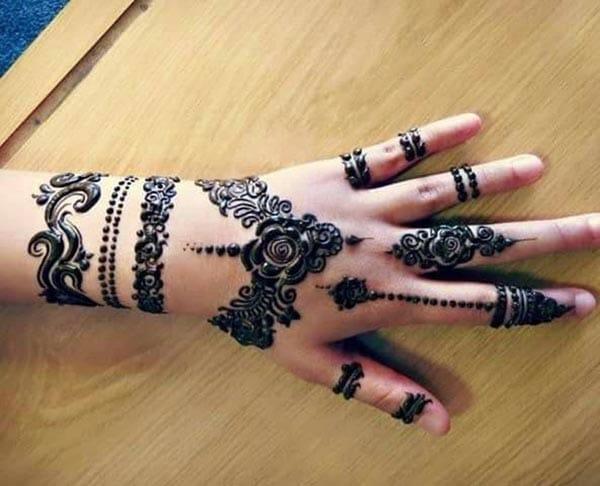 A marvelous rose henna design on back hand for girls