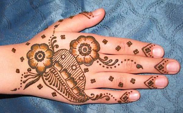 A lovely floral mehndi design on back hand for Ladies