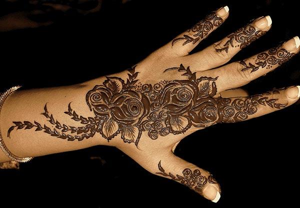 An intricate mehndi design on back hand for girls and women