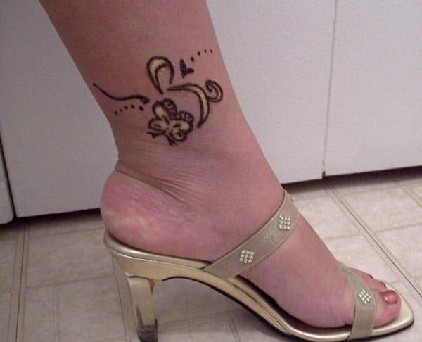 A cute little mehendi design on ankle for Women