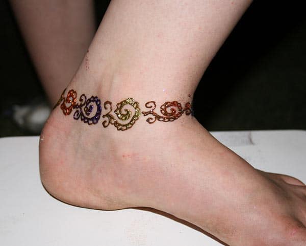 A vibrant ankle mehendi design for Girls