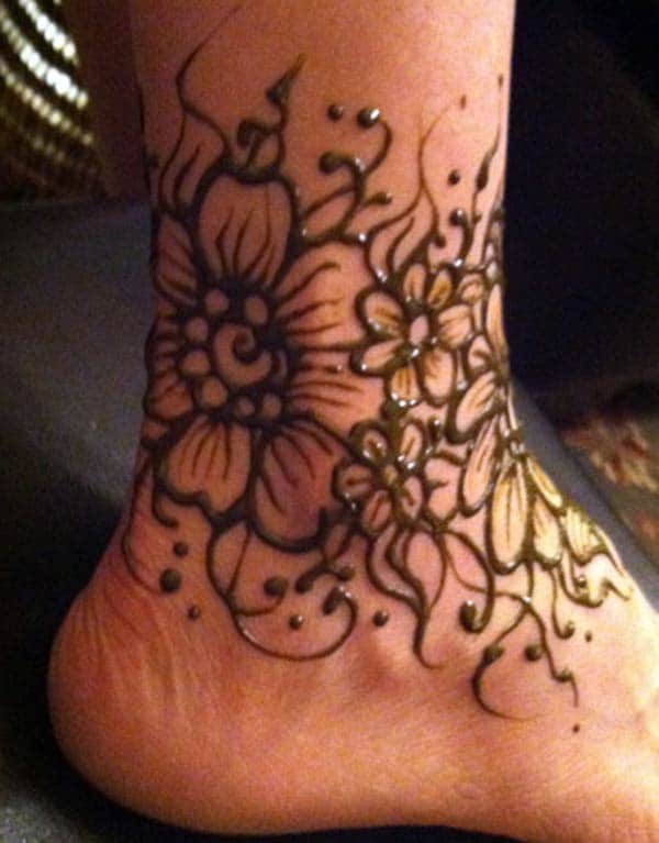 A floral hug mehendi design on ankle for Girls