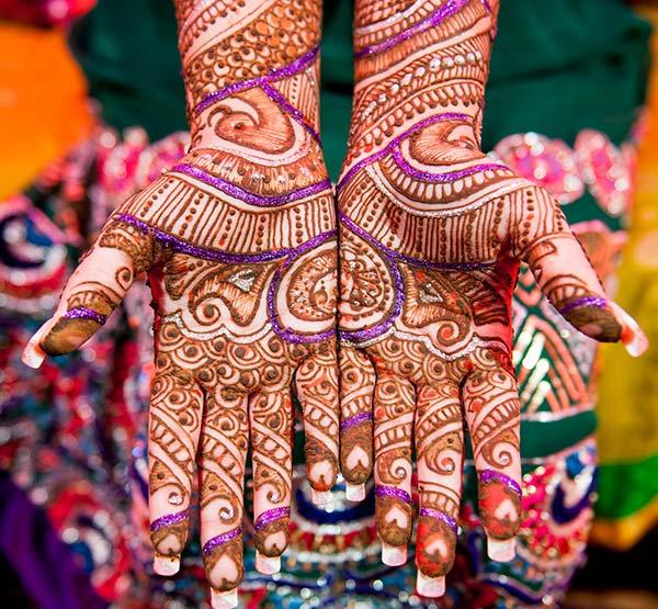 A vibrant stylish mehendi design on hand for brides