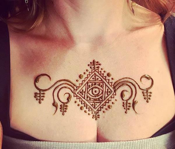 A symmetrical mehendi design on chest for Ladies