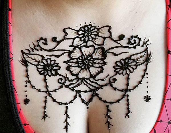 A floral hanging mehendi design on chest for Girls