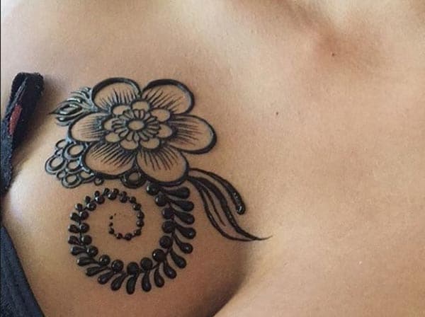 A bold mehendi design on chest for girls and women