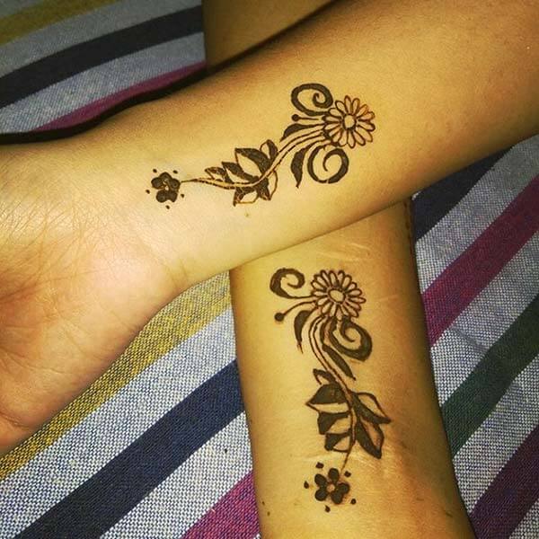 An appealing floral mehndi design on wrist for girls